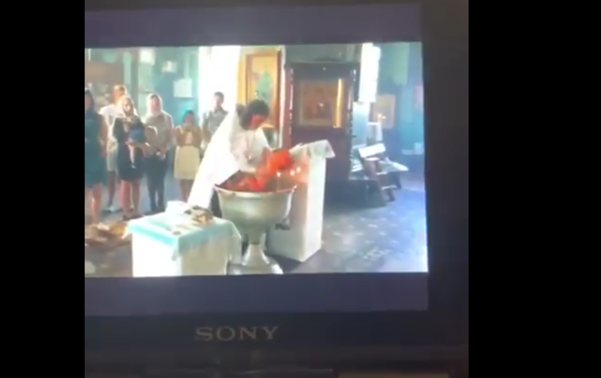 Кадры видео грубого крещения годовалого малыша в Гатчине. Фото Все - скриншот YouTube, "Metro"