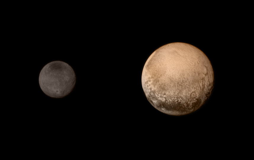 Плутон (справа) и один из его спутников – Харон (слева). Фото сделано станцией "Новые горизонты". Фото Getty